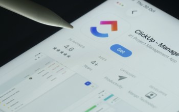 Dhaka, Bangladesh- 30 Oct 2025: ClickUp app on a iPad screen with a pen pointing at the install