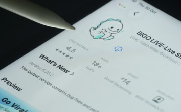 Dhaka, Bangladesh- 30 Oct 2025: Bigo Live app on a iPad screen with a pen pointing at the install