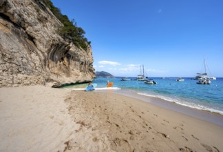 Sandy beach beach and steep cliffs at Cala Luna, Golfo di Orosei, Baunei, Sardinia, Italy