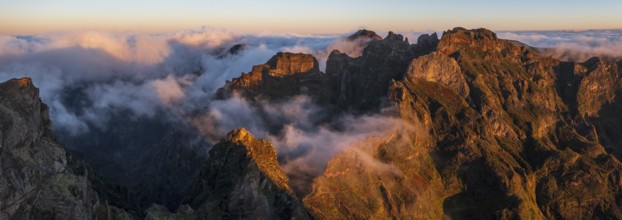 Aerial view, sunrise at Pico do Arieiro, clouds of fog sweeping over mountain peaks, Madeira,