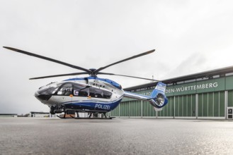 Helicopter from the Baden-Württemberg Police team in front of the hangar at the airport. Airbus