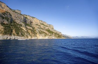 Picturesque rocky coast, cliffs in morning light, blue sea, Golfo di Orosei, Baunei, Sardinia,