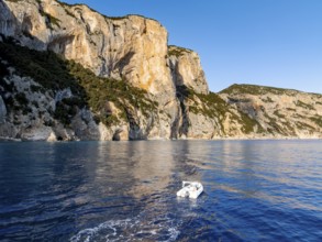 Motorboat rides on picturesque rocky coast ImmorgenLicht, cliffs, Golfo di Orosei, Baunei,