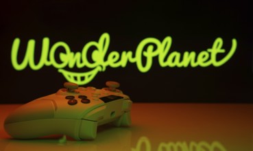 Dhaka, Bangladesh- 14 Nov 2025: A close-up of a white gamepad with the WonderPlanet Inc seen on