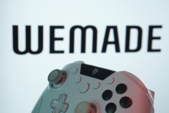 Dhaka, Bangladesh- 14 Nov 2025: A close-up of a gamepad with the WeMade Entertainment seen on