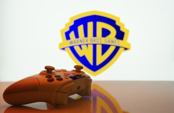 Dhaka, Bangladesh- 14 Nov 2025: A close-up of a white gamepad with the Warner Bros. Games seen on