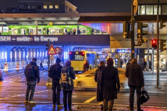 The main train station in Essen, blue illuminated underpass, bus station, am Europaplatz, train on