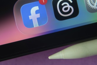 16 Nov 2025- Dhaka, Bangladesh: Facebook and other app icons with a digital pen on a iPad screen