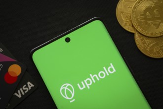 Dhaka, Bangladesh- 03 Sep 2025: Smartphone displaying Uphold logo surrounded by Bitcoin coins and