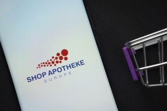Dhaka, Bangladesh- 21 Nov 2025: A smartphone displaying the Shop Apotheke logo next to a miniature