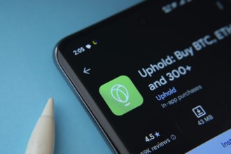 Dhaka, Bangladesh- 19 Sep 2025: On a blue surface, a smartphone displays the Uphold app within the