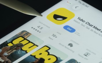 Dhaka, Bangladesh- 30 Oct 2025: Yubo app on a iPad screen with a pen pointing at the install option