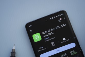 Dhaka, Bangladesh- 19 Sep 2025: On a blue surface, a smartphone displays the Uphold app within the