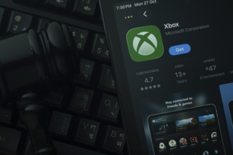 Dhaka, Bangladesh- 28 Oct 2025: An iPad displaying the Xbox app against a judge's gavel and dark
