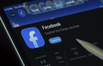 Dhaka, Bangladesh- 30 Oct 2025: Facebook app displayed on a iPad screen in dark mode with a digital