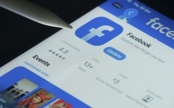 Dhaka, Bangladesh- 30 Oct 2025: Facebook app on a iPad screen with a pen pointing at the install