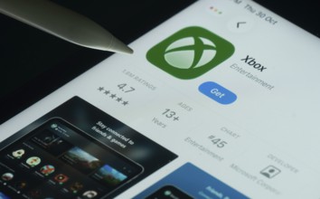 Dhaka, Bangladesh- 30 Oct 2025: Xbox app on a iPad screen with a pen pointing at the install option