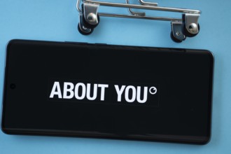 Dhaka, Bangladesh- 21 Nov 2025: Smartphone screen showing the About You logo with shopping cart