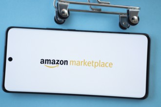 Dhaka, Bangladesh- 21 Nov 2025: Smartphone screen showing the amazon marketplace logo with shopping