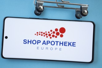 Dhaka, Bangladesh- 03 July 2025: Smartphone screen showing the (...) logo with shopping cart wheels