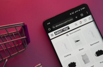 Dhaka, Bangladesh- 21 Nov 2025: A smartphone displaying the About You website with a shopping cart