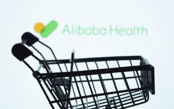 Dhaka, Bangladesh- 21 Nov 2025: Silhouette of a shopping cart in front of the Alibaba Health logo,