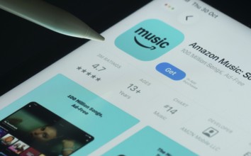 Dhaka, Bangladesh- 21 Nov 2025: Amazon Music app on a iPad screen with a pen pointing at the