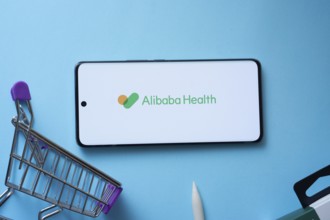 Dhaka, Bangladesh- 21 Nov 2025: Smartphone displaying Alibaba Health logo with shopping cart on a