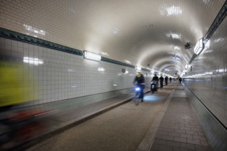 Interior view, pedestrians and cyclists crossing tunnel, mopping effect, movement, tube, historic