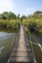Toruist on the Kavango River, suspension bridge at Camp Kwando, Zambezi region, Caprivi Strip,