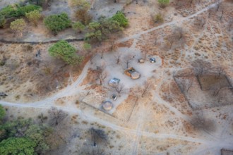 Settlement, simple house and fence, dry savanna landscape, near Maun, aerial view, Okavango Delta,