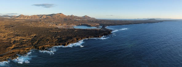 Coast with lava fields, volcanic landscape near Los Hervideros, in the evening light, aerial view,