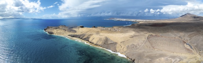 Coast with Playa Caleta del Congrio beach and blue sea, arid landscape of Los Ajaches Natural Park,