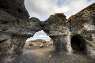 Eroded rock formations, volcanic landscape with dramatic cloudy skies, Ciudad Estratificada or Los