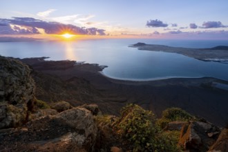 View from steep cliffs to sea and coast with sun stars, Mirador del Porrito viewpoint at sunset,
