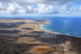 View from the Risco de Famara cliffs to the coast and the sea with the Famara beach, Playa de
