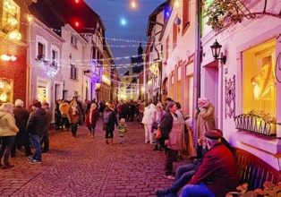 People in the Tiefstraße decorated for the Martin train in the evening, historic old town, Kempen,