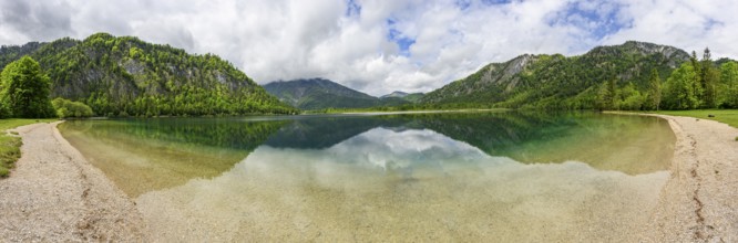 Landscape of Lake Offensee after rain when the sun comes through the clouds in spring,