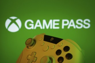Dhaka, Bangladesh- 01 Nov 2025: A close-up of a gamepad with the Xbox Game Pass seen on screen in
