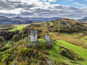 Autumn colours over Castell Dolwyddelan and Eryri Mountains from a drone, Snowdonia, Conwy County