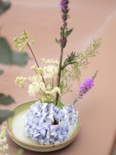Floral arrangement made with hydrangea, meadowsweet and purple loosestrife during an ikebana