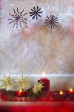 Christmassy decorated iced window, candle light, straw stars, Germany