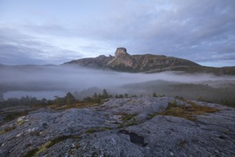 Magical morning fog on Steigtindvatnet in front of the majestic Steigtinden in Norway near Bodø