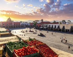 Traditional Mexican plaza with crates of peppers, onions, and tomatoes, economic prosperity in