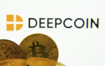 Dhaka, Bangladesh- 03 Oct 2025: Close-up of Bitcoin coins with the Deepcoin logo visible on a