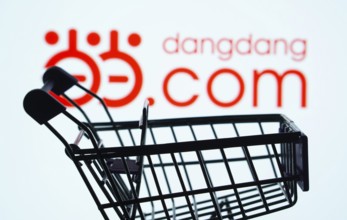 Dhaka, Bangladesh- 03 Oct 2025: Silhouette of a shopping cart in front of the Dangdang.com logo,
