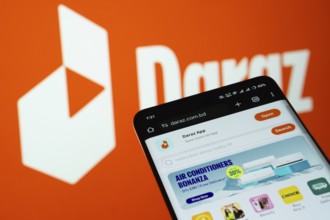 Dhaka, Bangladesh- 03 Oct 2025: Smartphone displaying Daraz web interface against Daraz logo