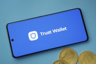 Dhaka, Bangladesh- 30 Sep 2025: Trust Wallet logo on smartphone screen near Bitcoin coin and QR