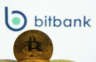 Dhaka, Bangladesh- 02 June 2025: Close-up of Bitcoin coins with the bitbank logo visible on a