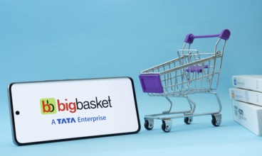 Dhaka, Bangladesh- 03 July 2025: Smartphone with BigBasket logo next to a small shopping cart and